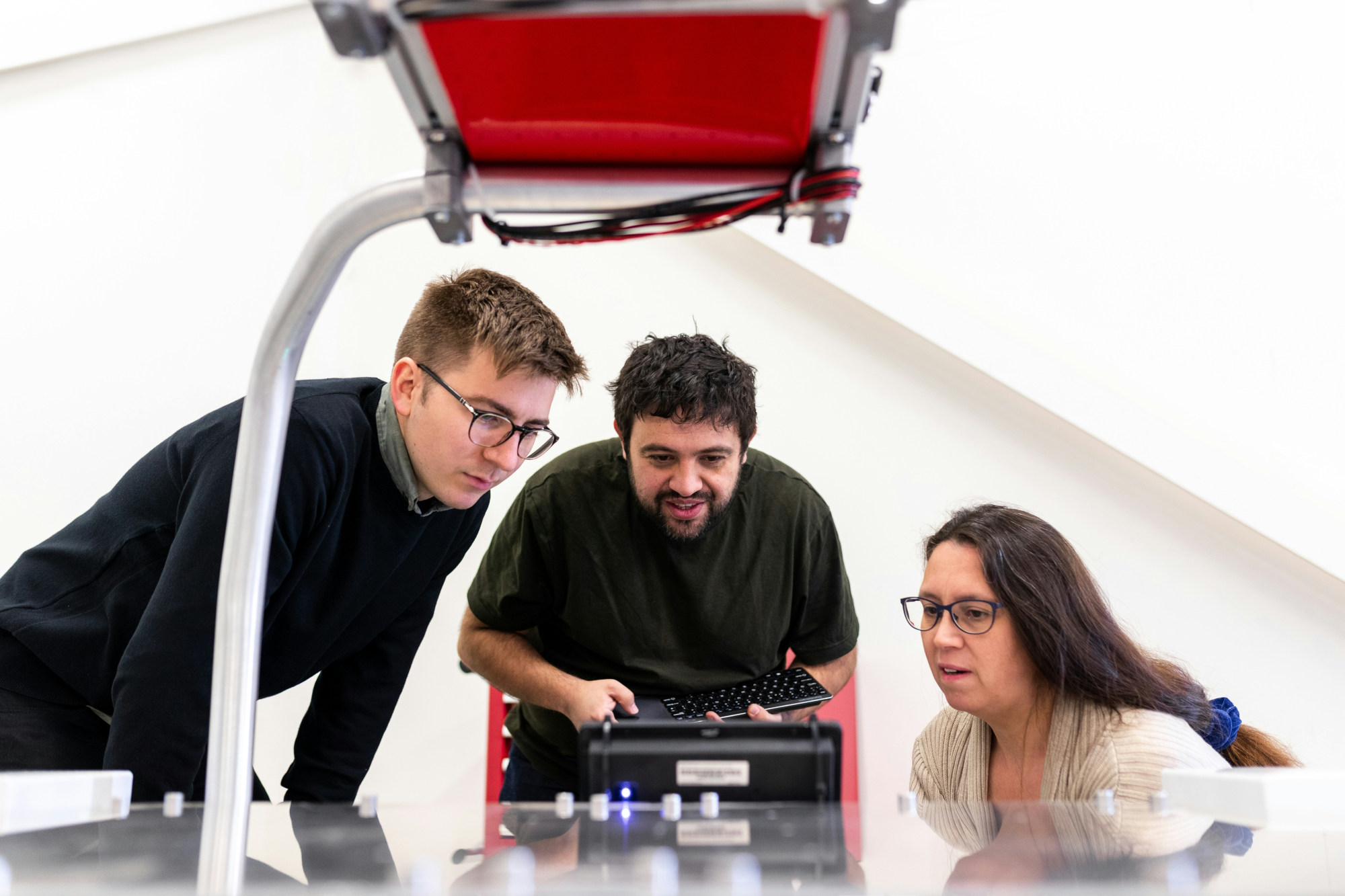 Three engineers working on a project, and seems like hitting the keyboard to run their code.